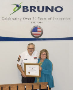 Theresa of Bruno accepts a certificate of recognition from the VFW for their part in the donation