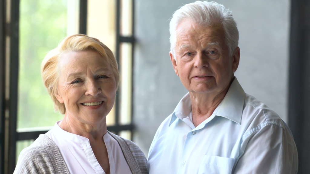 loving-and-happy-elderly-couple-in-a-modern-apartment-they-talk-smile-and-looking-at-the-camera_stnlfdvq__F0010