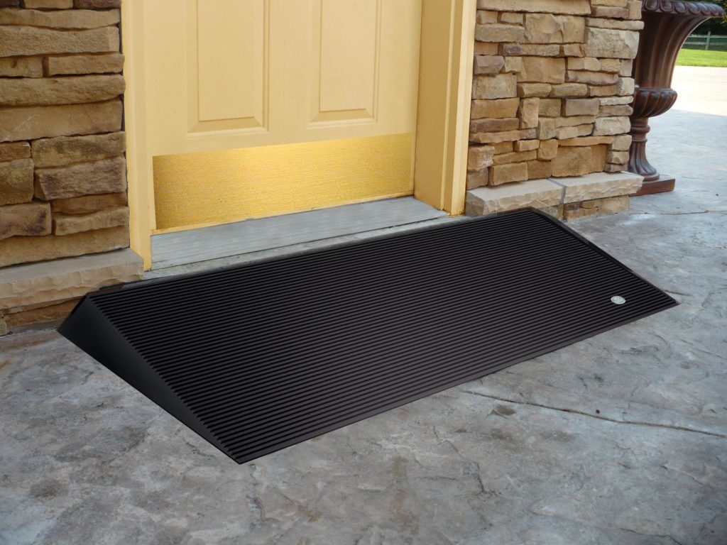 Portable handicap ramp over the entryway of a door