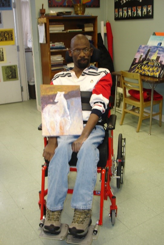Derrick holding a painting