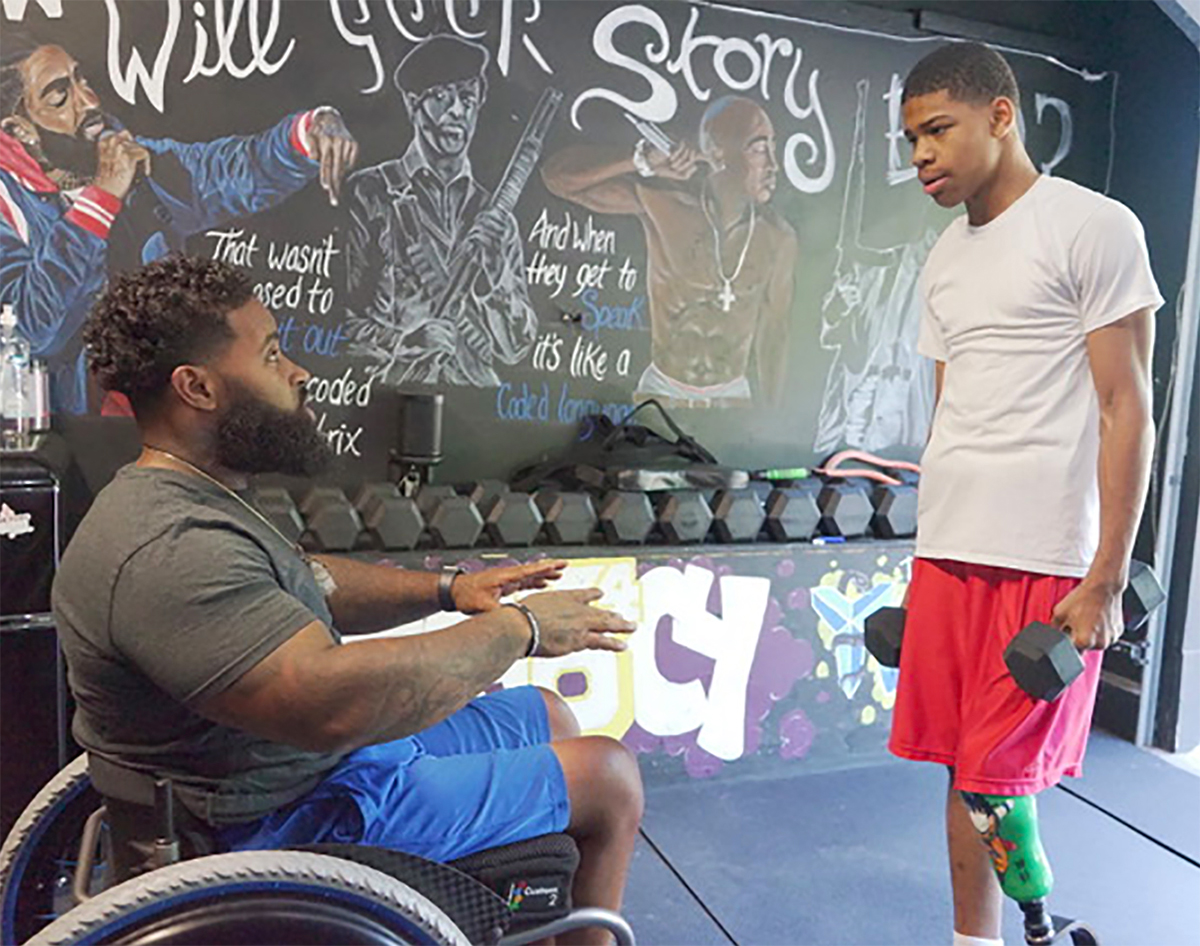Wes Hamilton talks with a young participant in Disabled But Not Really, the inclusive fitness community Hamilton founded to serve Kansas City’s east side. “How can they grow if growth isn’t represented by us?” he asked on Instagram.