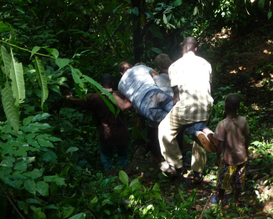 Robinson is plank-carried through a Ghanese jungle to see a spectacular waterfall.