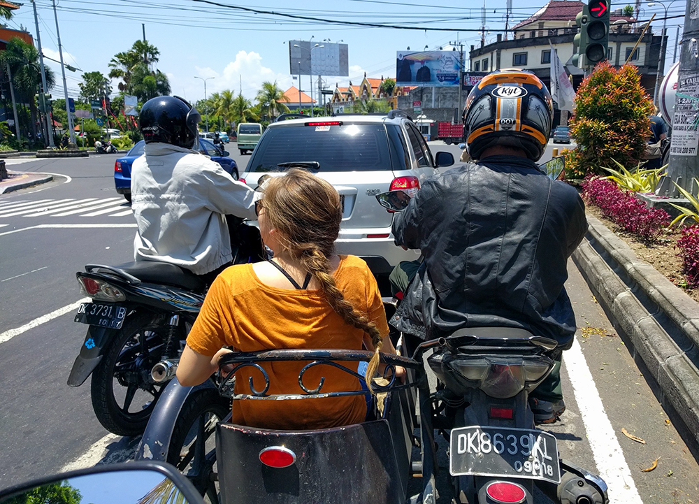 Chambers rides in a sidecar through the streets of Bali.